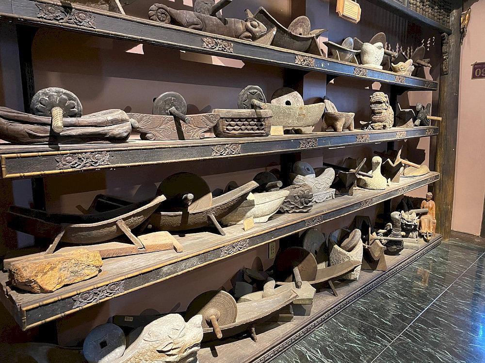 The exhibition area showcases the herbalist’s mortar and root slicer used in traditional medicine preparation